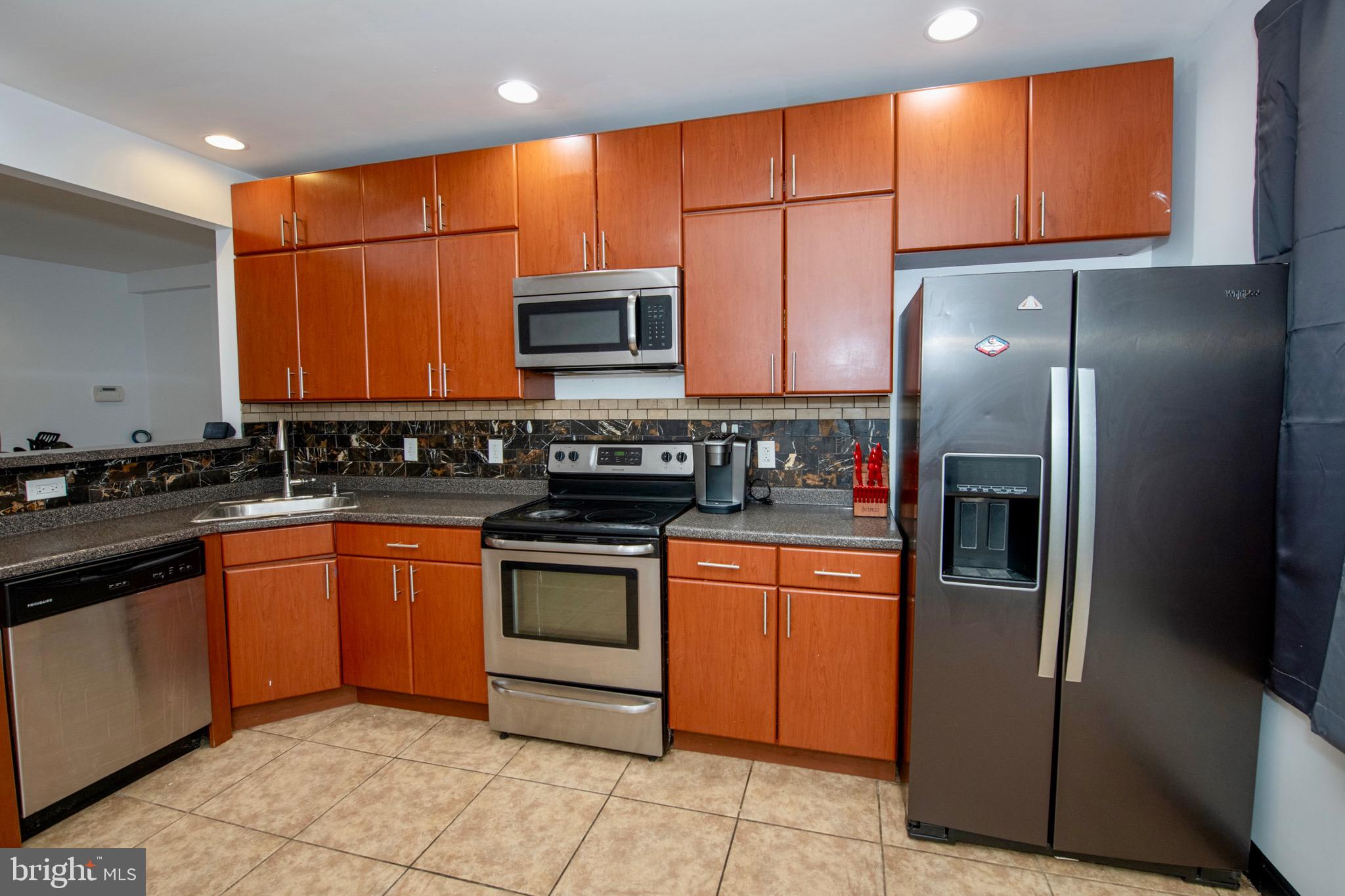 4930 Pulaski Avenue Philadelphia, PA 19144 - Photo 7 of 21 a kitchen with stainless steel appliances granite countertop a refrigerator and a stove top oven