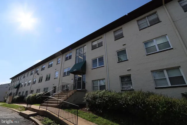 a large building with a large window and yard