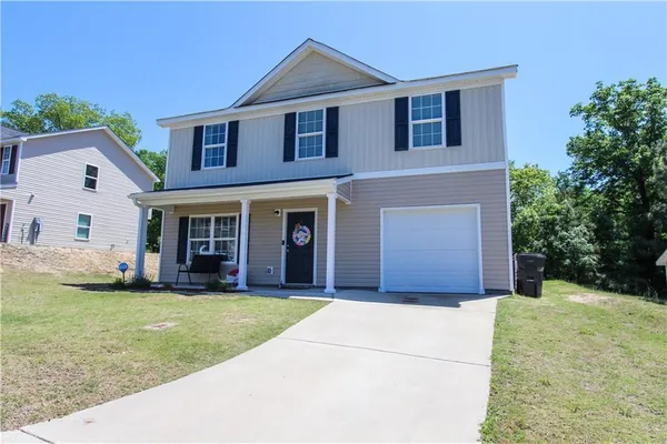 a front view of a house with a yard and garage