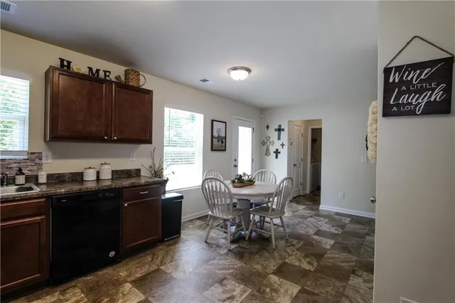 a kitchen with granite countertop sink cabinets and stainless steel appliances
