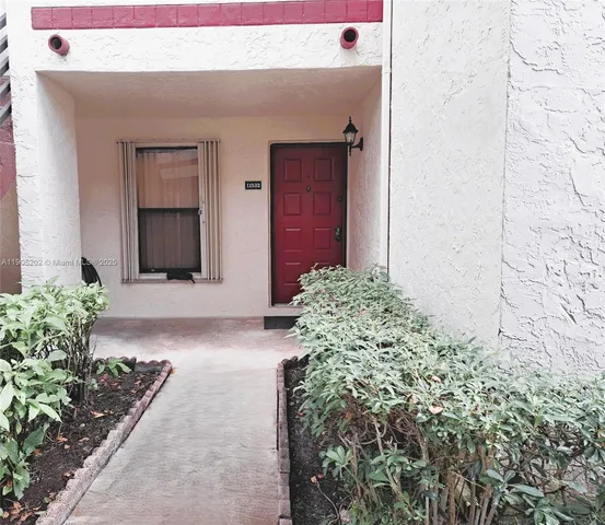 a living room with a bed and a wooden floor