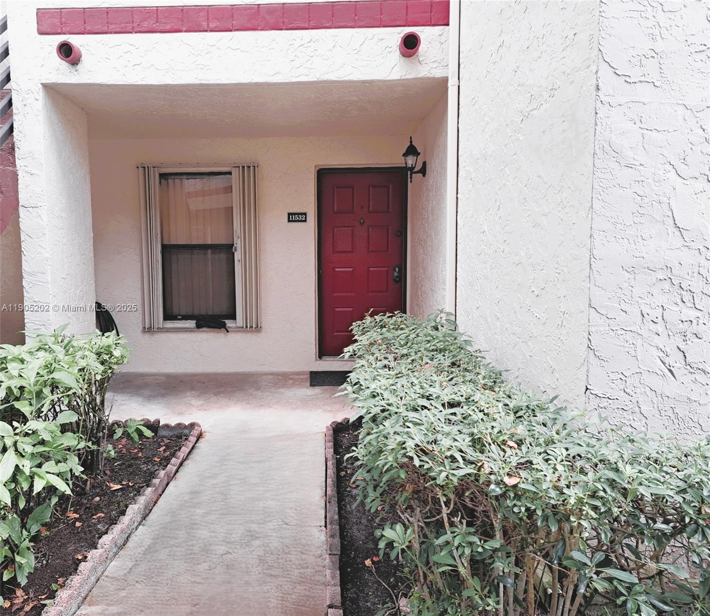 11532 Northwest 10th Street, Unit 11532 Pembroke Pines, FL 33026 - Photo 12 of 16 front view of a house with a yard