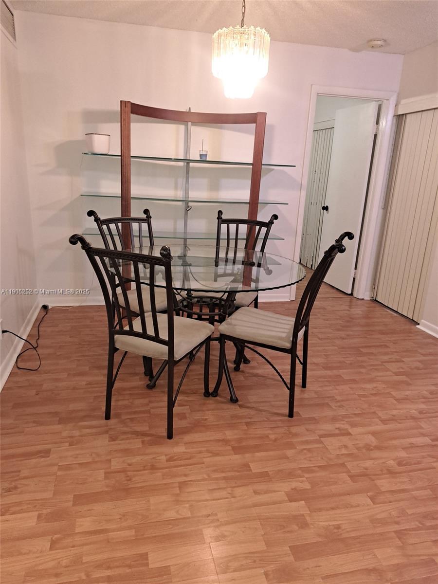 11532 Northwest 10th Street, Unit 11532 Pembroke Pines, FL 33026 - Photo 15 of 16 a view of a room with furniture and wooden floor