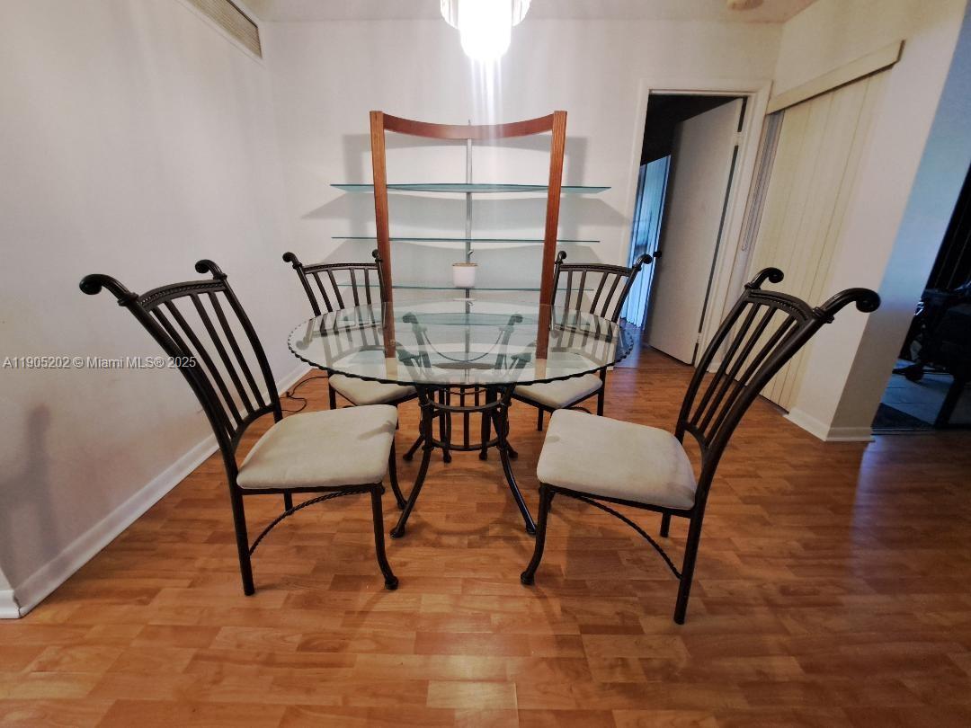 11532 Northwest 10th Street, Unit 11532 Pembroke Pines, FL 33026 - Photo 3 of 16 a view of a livingroom with furniture and a table and chair
