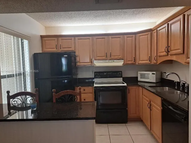 a kitchen with a sink cabinets and stainless steel appliances