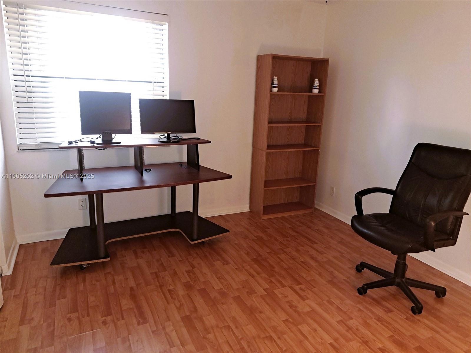 11532 Northwest 10th Street, Unit 11532 Pembroke Pines, FL 33026 - Photo 6 of 16 a view of a workspace with furniture and a window