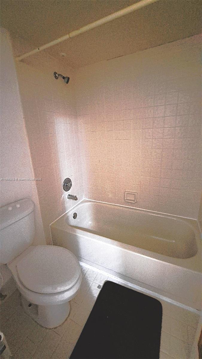11532 Northwest 10th Street, Unit 11532 Pembroke Pines, FL 33026 - Photo 8 of 16 a bathroom with a toilet a sink and bathtub