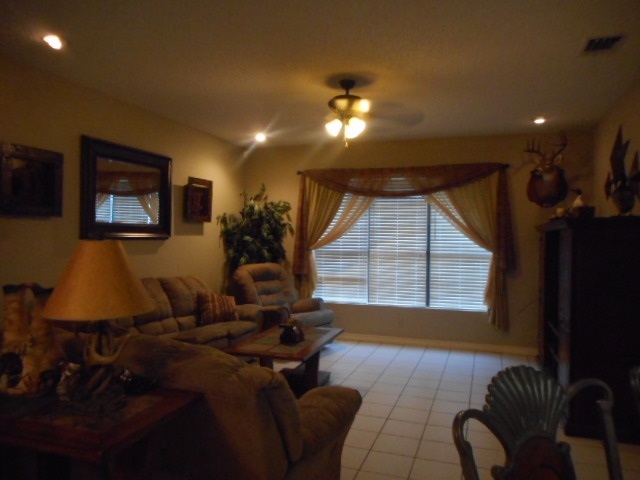 712 Merlin Road Laredo, TX 78041 - Photo 4 of 9 a living room with furniture a window and a flat screen tv