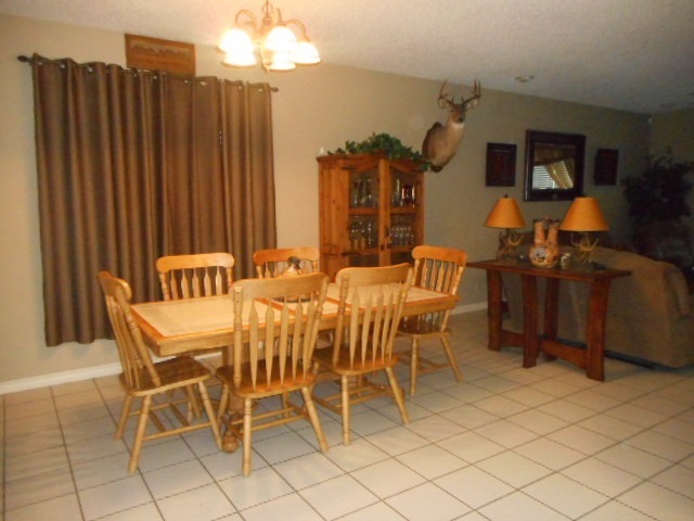 712 Merlin Road Laredo, TX 78041 - Photo 5 of 9 a dining room with furniture a chandelier and kitchen view