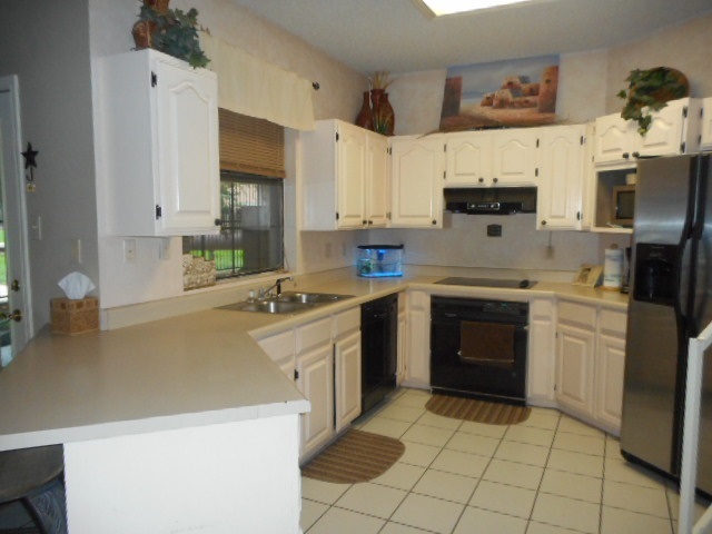 712 Merlin Road Laredo, TX 78041 - Photo 6 of 9 a kitchen with stainless steel appliances granite countertop a sink and a stove