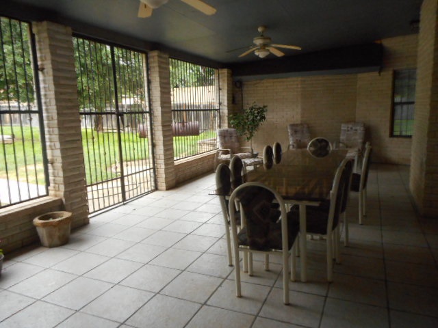 712 Merlin Road Laredo, TX 78041 - Photo 7 of 9 a dining room with furniture and a floor to ceiling window