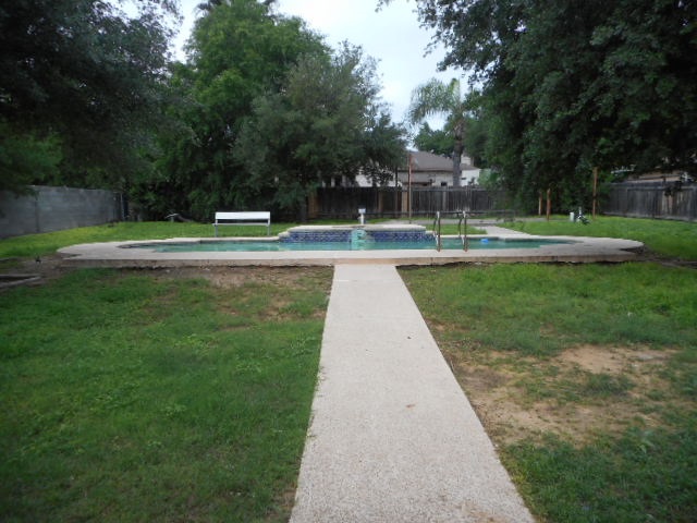 712 Merlin Road Laredo, TX 78041 - Photo 8 of 9 a view of swimming pool with a garden and trees