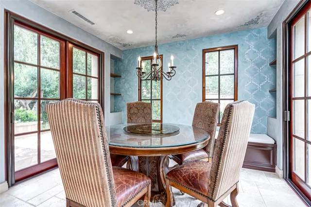 a dining room with furniture a chandelier and wooden floor