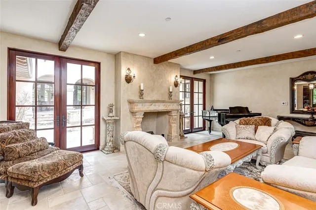 a living room with furniture a fireplace and a large window