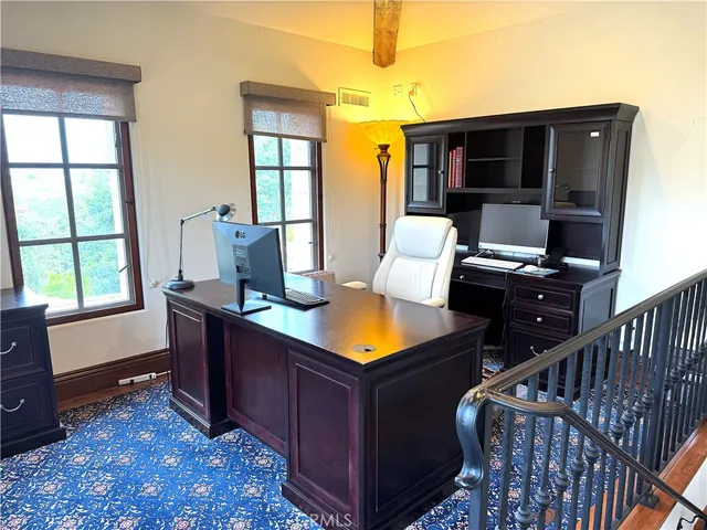 a room with furniture pool table and windows