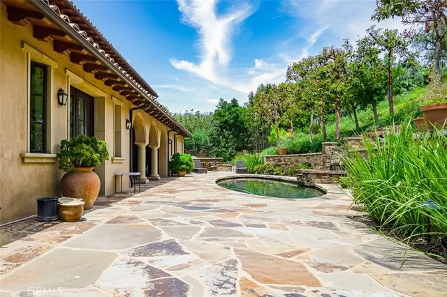 a view of house with backyard and outdoor seating