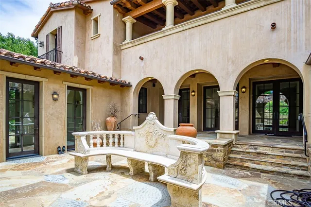 a front view of a house with outdoor seating