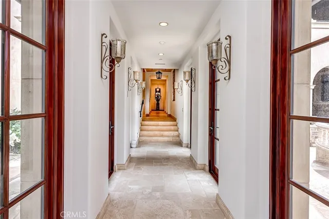 a view of a hallway with a door and stairs