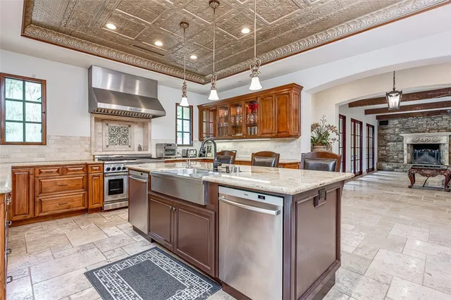 a kitchen with stainless steel appliances granite countertop a stove and a sink