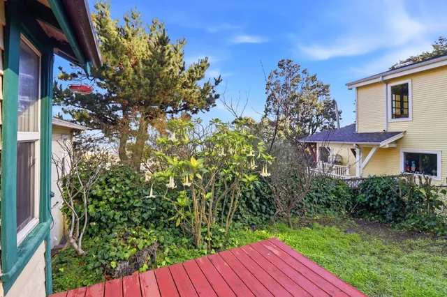 a view of a house with a flower garden