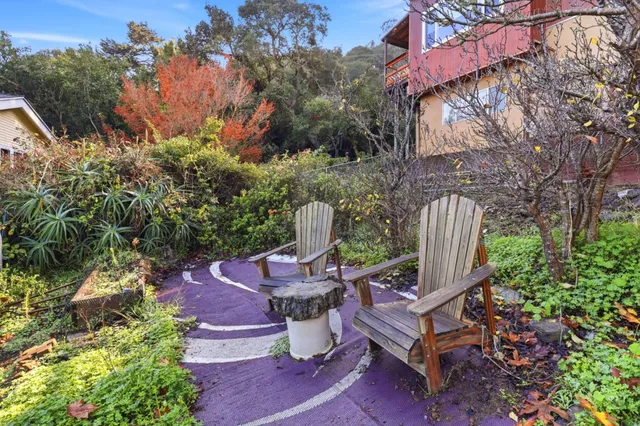 a view of a chairs and table in backyard