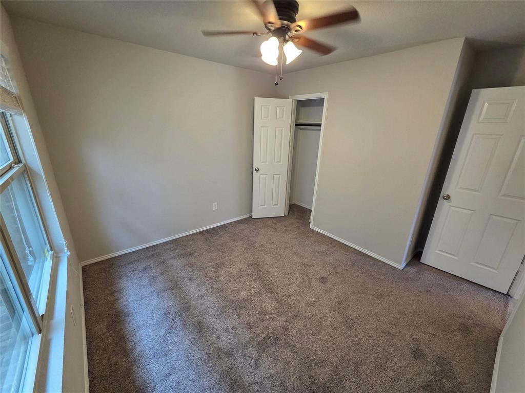 7504 Boat Wind Road Fort Worth, TX 76179 - Photo 6 of 17 an empty room with windows and fan