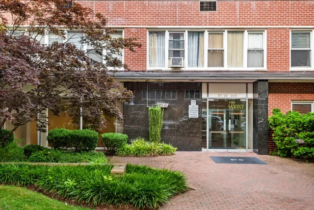 a front view of a building with garden