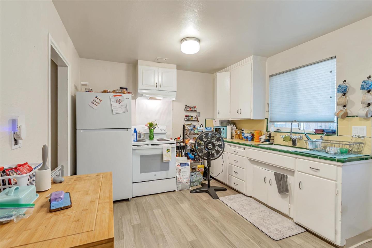 22620 Alcalde Road Cupertino, CA 95014 - Photo 11 of 39 a kitchen with white cabinets and white appliances