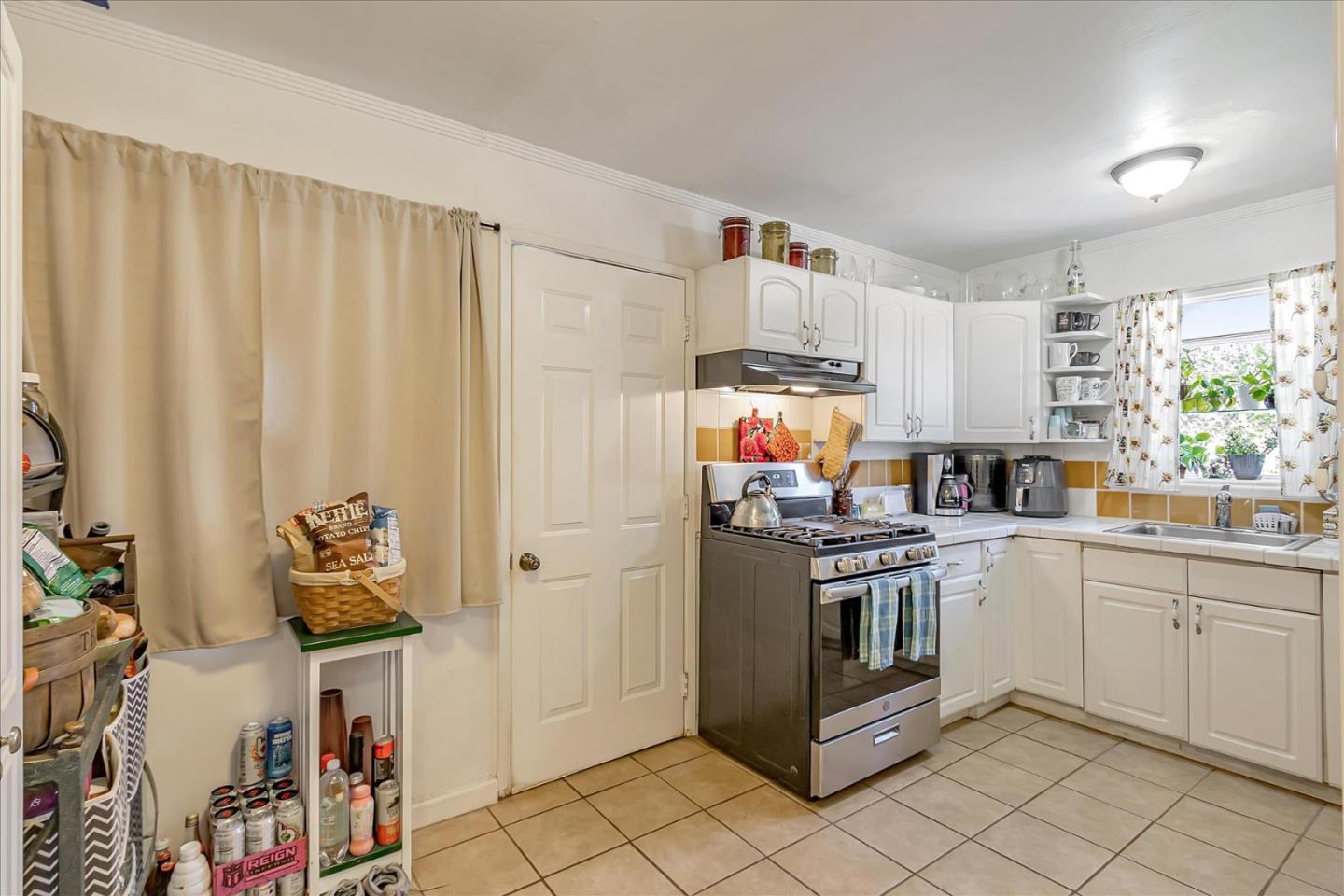 22620 Alcalde Road Cupertino, CA 95014 - Photo 13 of 39 a kitchen with stainless steel appliances a stove a sink and a refrigerator