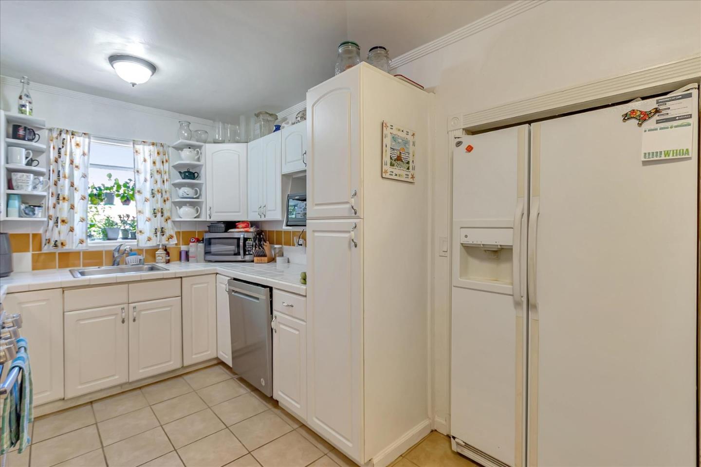 22620 Alcalde Road Cupertino, CA 95014 - Photo 15 of 39 a kitchen with white cabinets and white appliances
