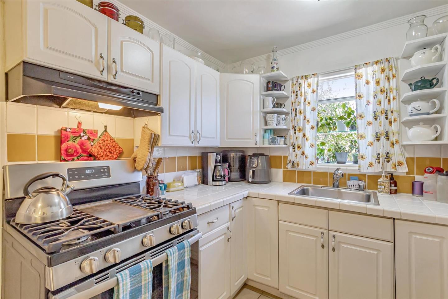 22620 Alcalde Road Cupertino, CA 95014 - Photo 16 of 39 a kitchen with stainless steel appliances a stove a sink and a microwave