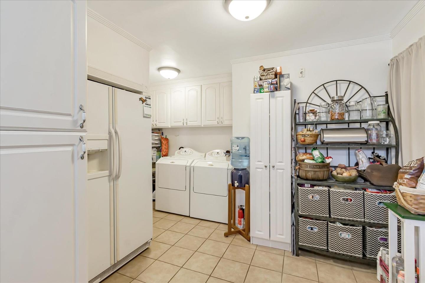 22620 Alcalde Road Cupertino, CA 95014 - Photo 17 of 39 a storage room with cabinets washer and dryer