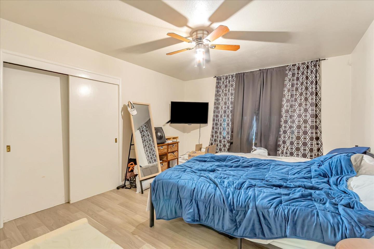 22620 Alcalde Road Cupertino, CA 95014 - Photo 23 of 39 a bedroom with a bed and a flat screen tv