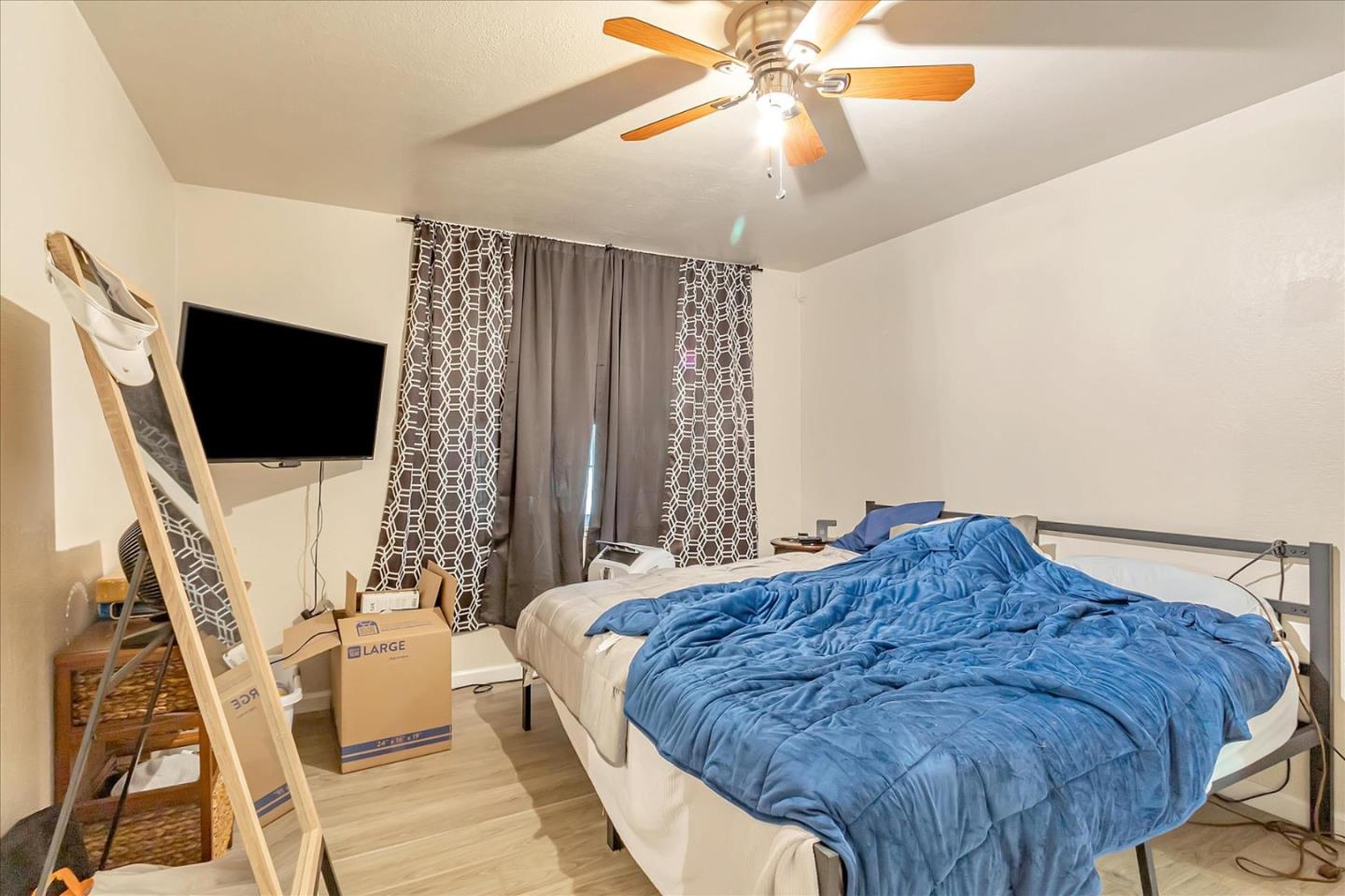 22620 Alcalde Road Cupertino, CA 95014 - Photo 24 of 39 a bedroom with a bed and a flat screen tv