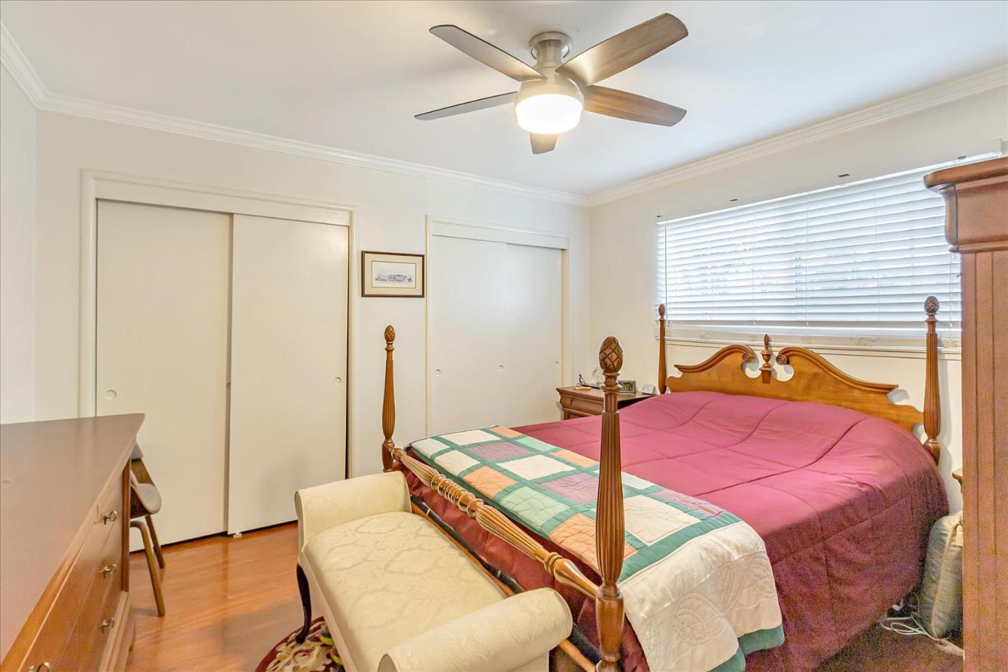 22620 Alcalde Road Cupertino, CA 95014 - Photo 26 of 39 a bedroom with a bed and a chandelier