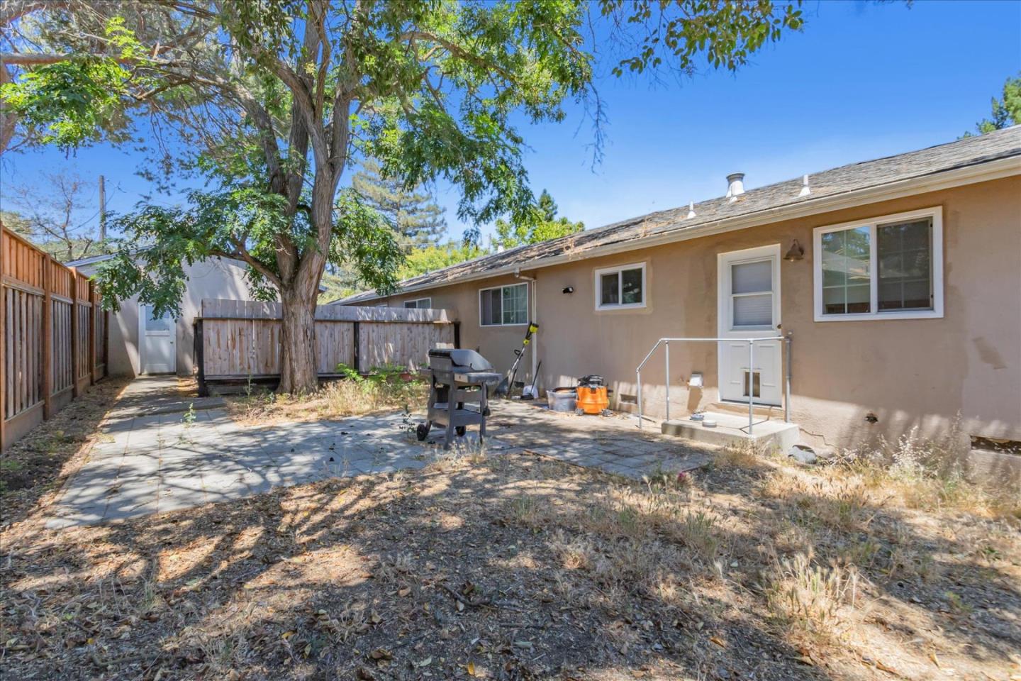 22620 Alcalde Road Cupertino, CA 95014 - Photo 32 of 39 a backyard of a house with table and chairs