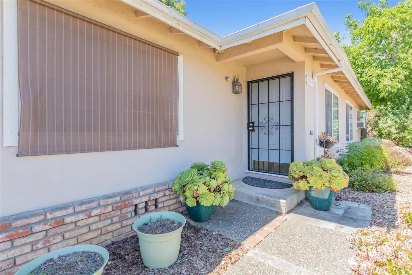 22620 Alcalde Road Cupertino, CA 95014 - Photo 4 of 39 a potted plant sitting in front of a house