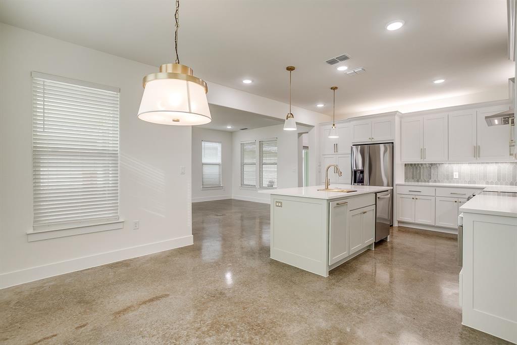 106 Cardinal Wds Granbury, TX 76049 - Photo 12 of 22 a large white kitchen with kitchen island a chandelier stainless steel appliances cabinets and a counter top space