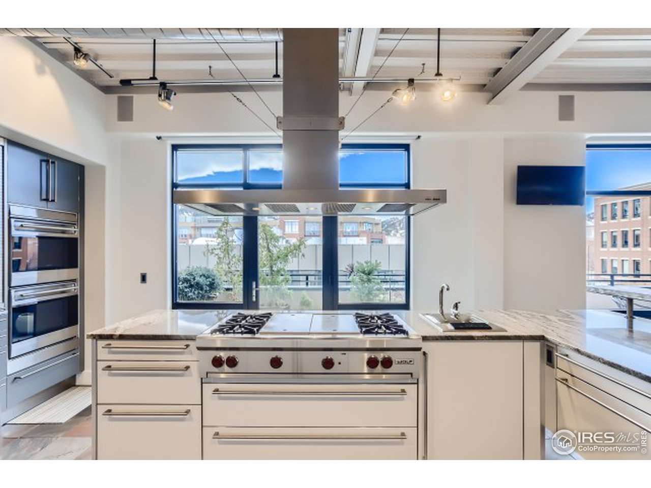 1360 Walnut Street, Unit 301 Boulder, CO 80302 - Photo 11 of 40 a kitchen with stainless steel appliances granite countertop a stove and a sink