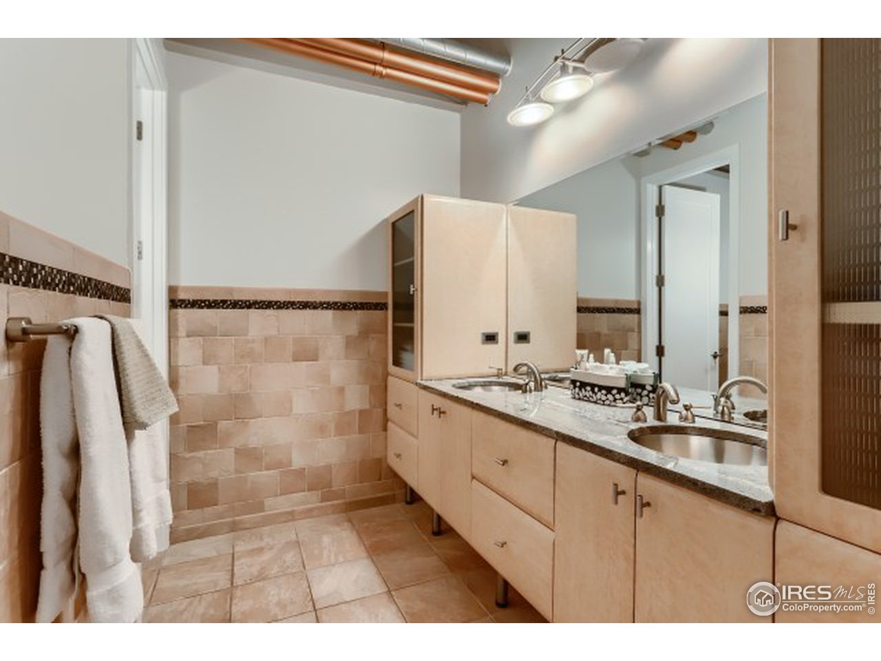 1360 Walnut Street, Unit 301 Boulder, CO 80302 - Photo 26 of 40 a bathroom with a double vanity sink a mirror and a shower