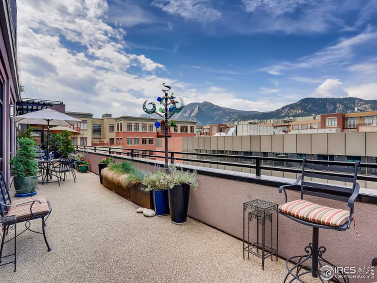 1360 Walnut Street, Unit 301 Boulder, CO 80302 - Photo 30 of 40 a balcony with furniture and a potted plant
