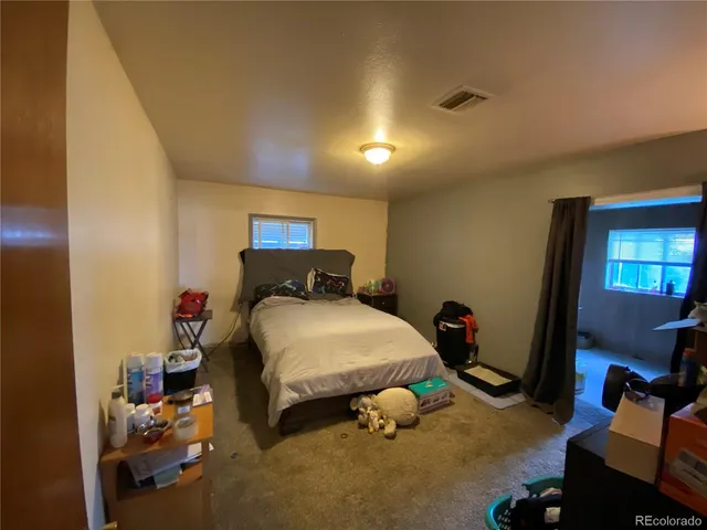 a bed sitting in a room next to a window