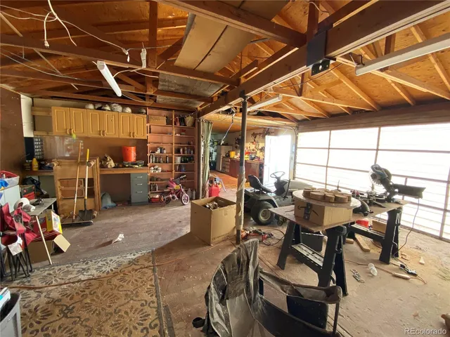 a kitchen with lots of clutter and stainless steel appliances