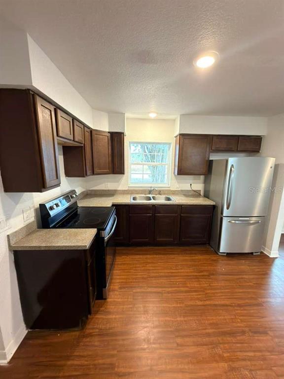 33 Sand Mountain Road Fort Meade, FL 33841 - Photo 3 of 9 a kitchen with stainless steel appliances a sink a stove a microwave a sink a refrigerator and cabinets