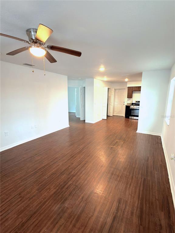 33 Sand Mountain Road Fort Meade, FL 33841 - Photo 4 of 9 a view of a room with wooden floor and a ceiling fan