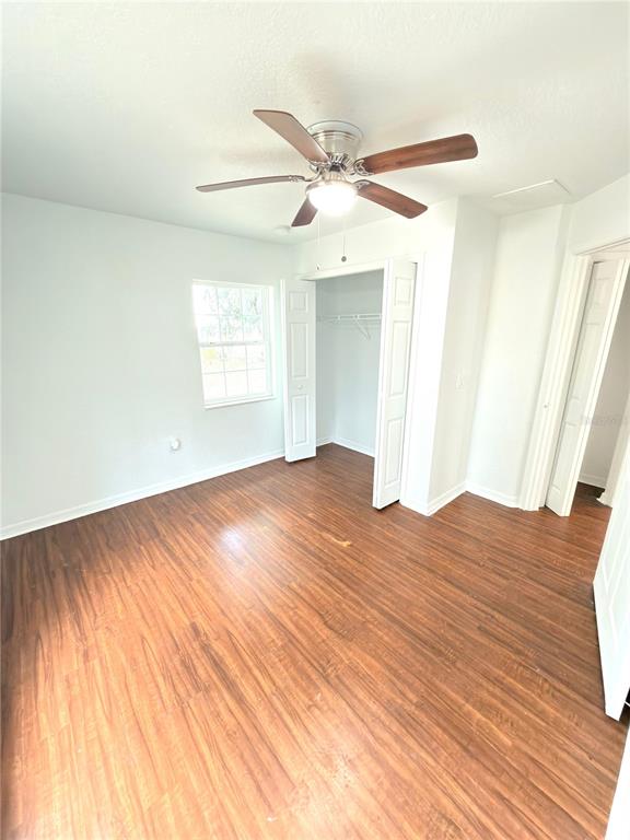 33 Sand Mountain Road Fort Meade, FL 33841 - Photo 5 of 9 an empty room with wooden floor fan and windows