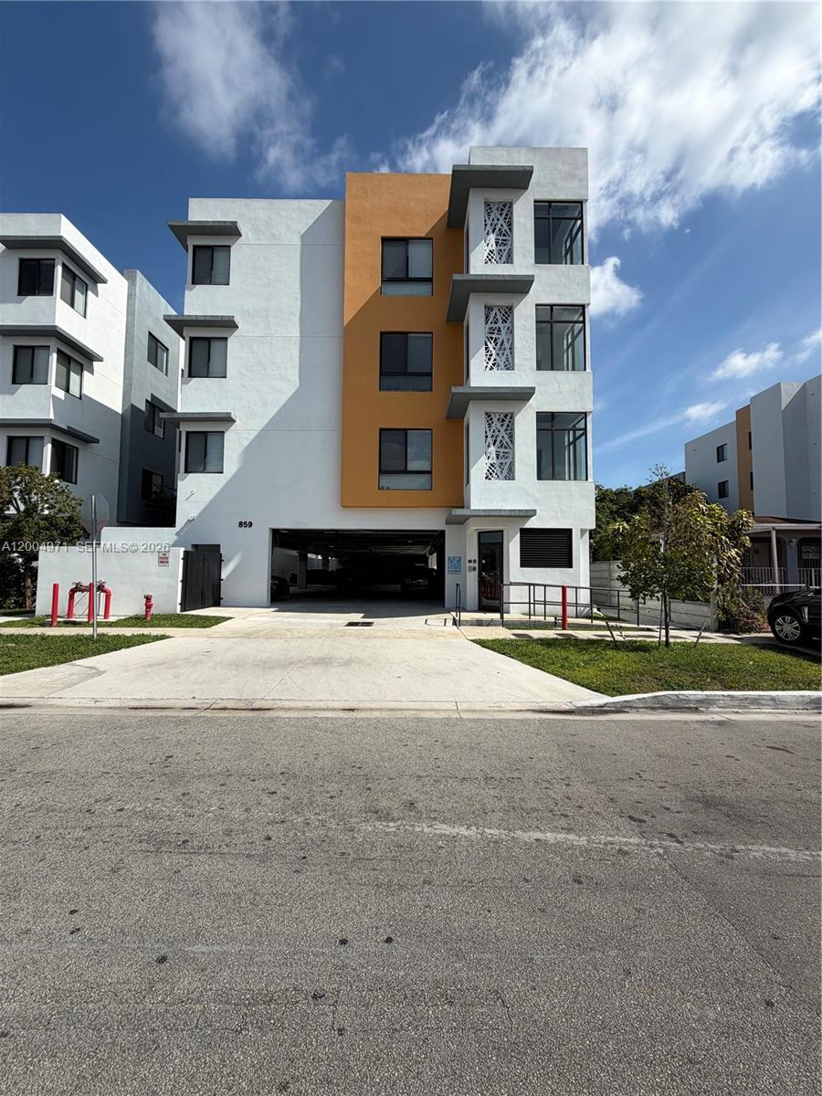 853 East 24th Street, Unit 203 Hialeah, FL 33013 - Photo 1 of 13 a large building with a large windows