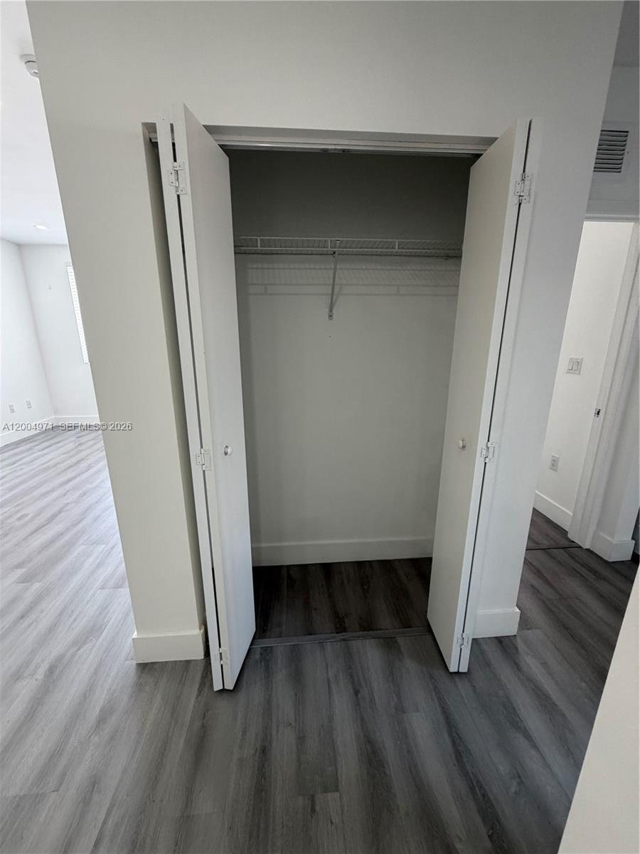 853 East 24th Street, Unit 203 Hialeah, FL 33013 - Photo 6 of 13 wooden floor in an empty room