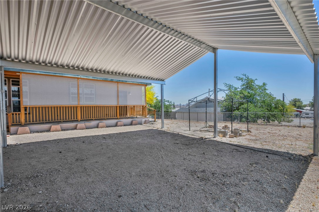 225 California Street Searchlight, NV 89046 - Photo 8 of 64 A spacious covered patio provides a shaded outdoor area with open views of the backyard.