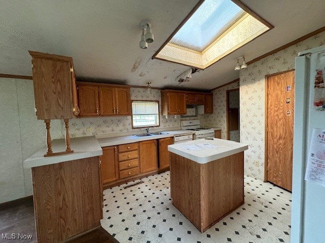 8089 Giddings Road Rootstown, OH 44272 - Photo 4 of 8 Kitchen with crown molding, white appliances, a kitchen island, and sink